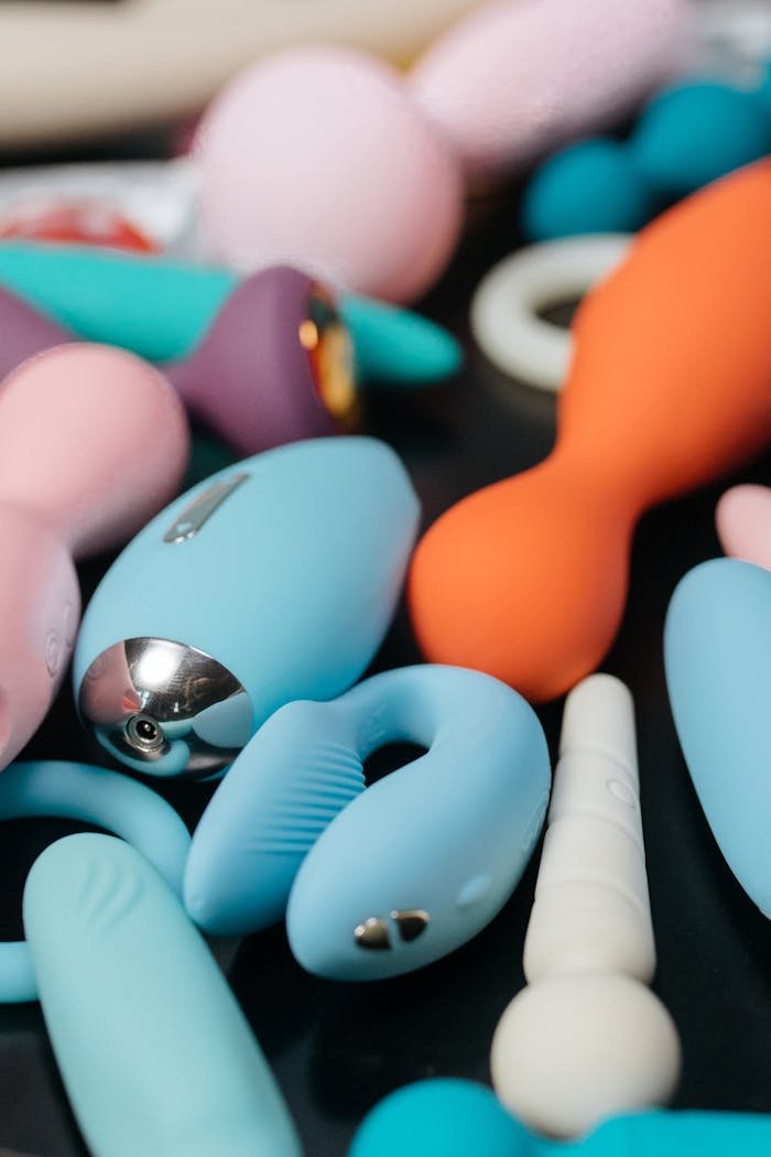 Vibrant close-up of assorted sleek and modern sex toys, showcasing different shapes and colors.